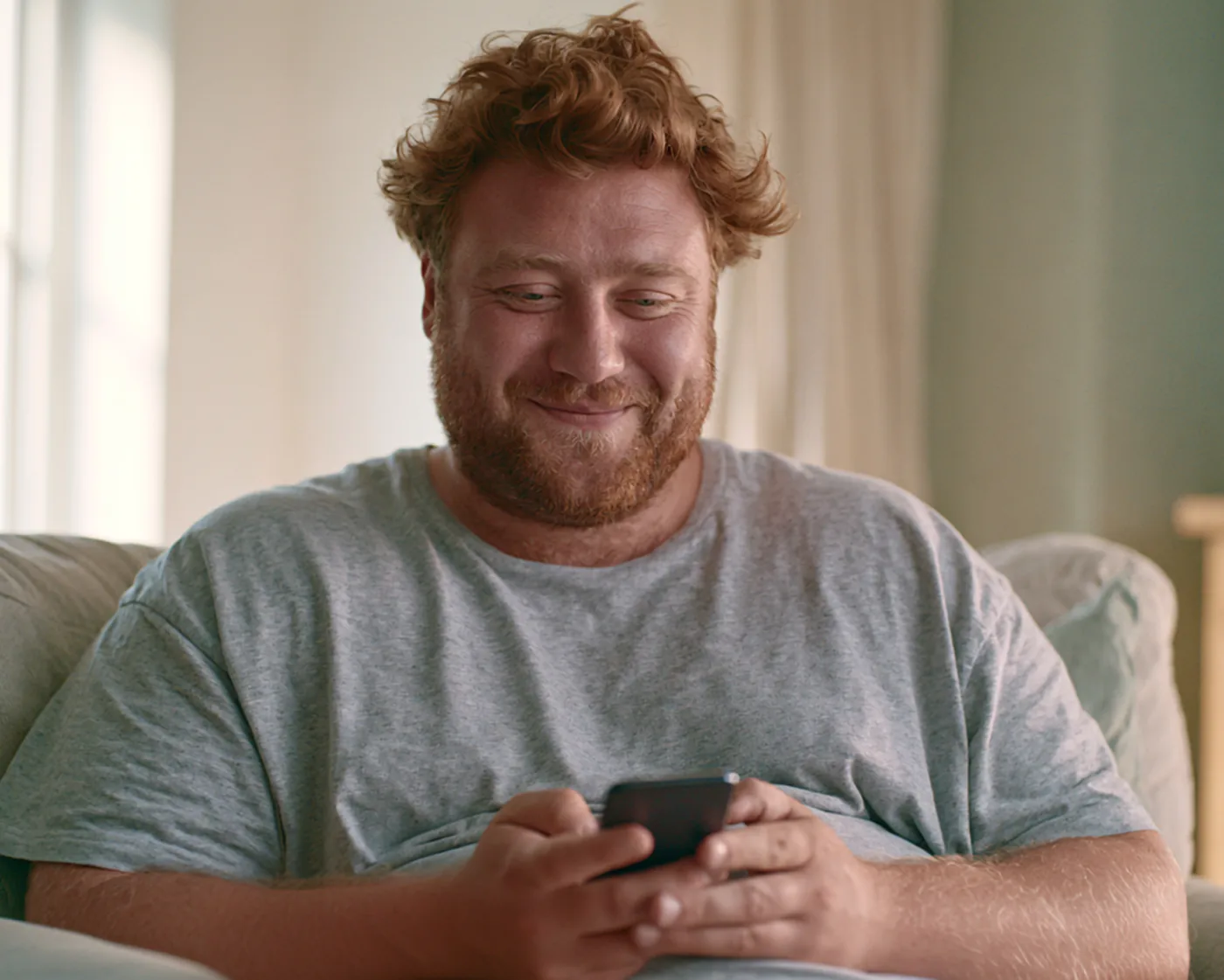 Man at home taking the InstaRx GLP-1 assessment on his phone