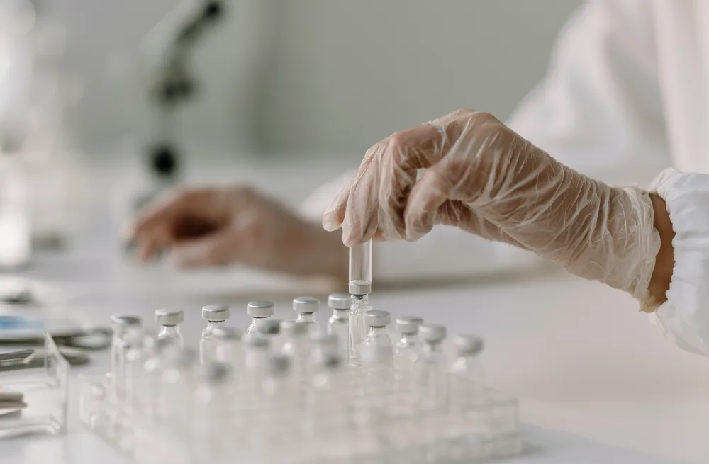 A technician testing NAD+ vials in a U.S. compounding pharmacy lab